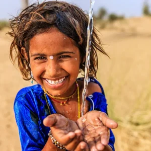 A little girl in Thar desert seems to be happy after drinking water